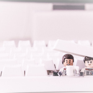 Photo of two Lego mini figures inside a computer keyboard.