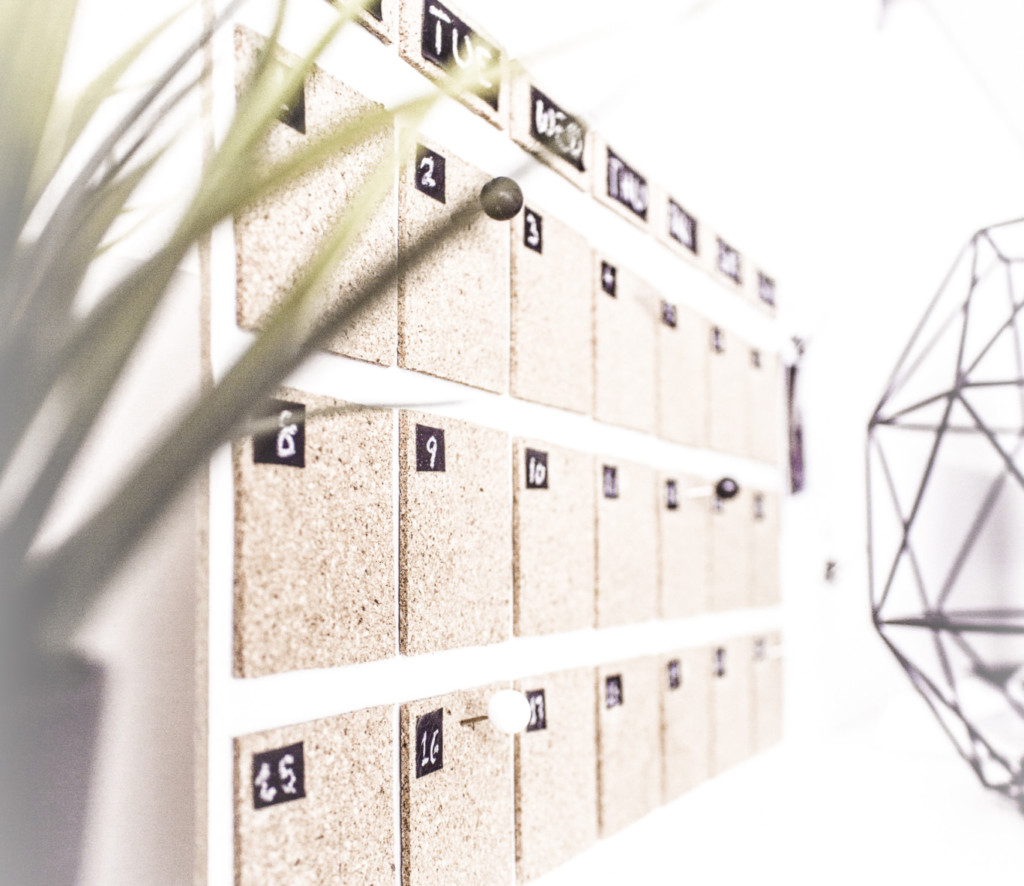 Photo of a corkboard calendar on a modern desk.
